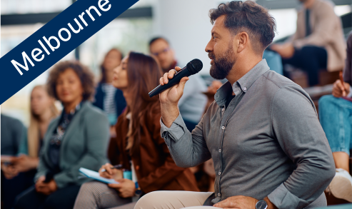 Man speaking into microphone at an event